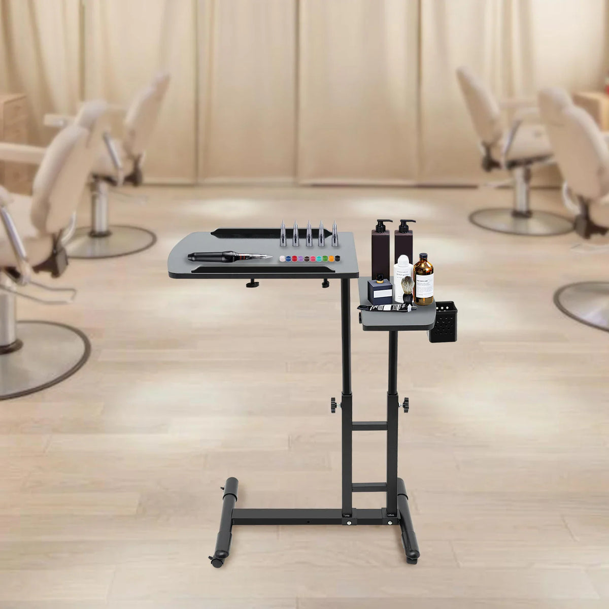 Black portable adjustable tattoo workstation table in a professional studio setting