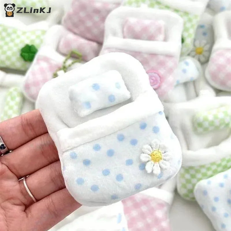 Small blue polka dot plush sleeping bag accessory with a daisy flower applique