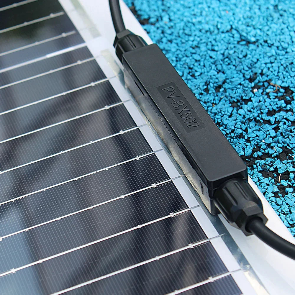 Close-up of the junction box and wiring connection on a flexible solar panel