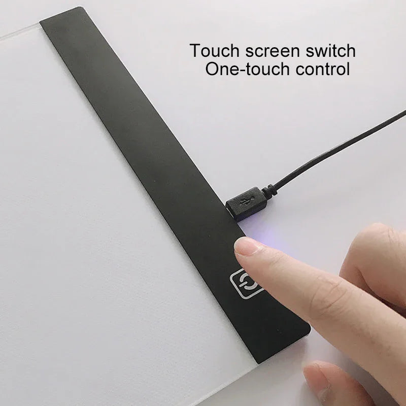 A close-up of a finger operating the touch screen power button on an LED light tracing board.