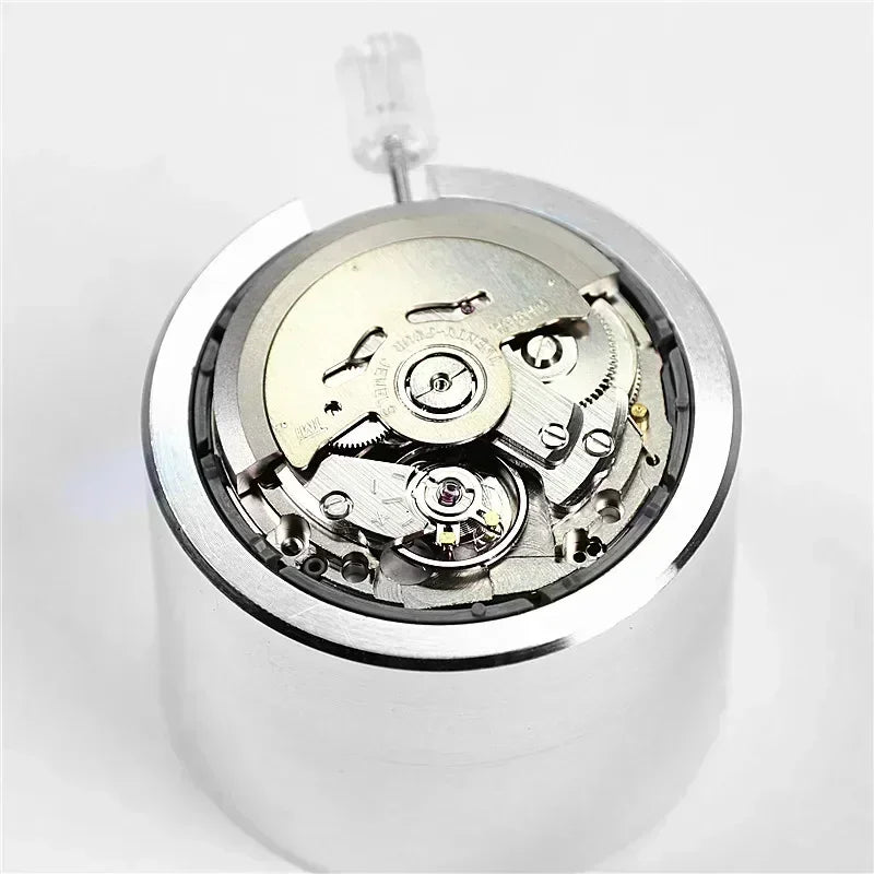 Mechanical automatic watch movement resting on a silver holder