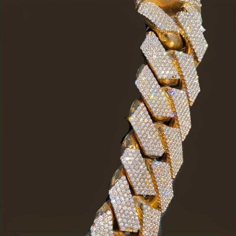 Macro shot of links on a gold-tone chain encrusted with clear cubic zirconia crystals