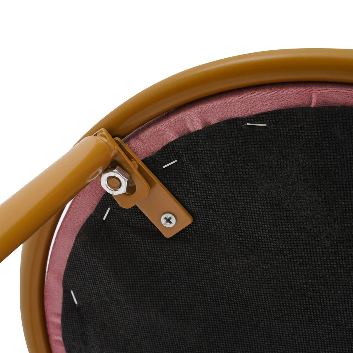 Close up detail of the metal bolt and bracket attaching the gold leg to the underside of the pink velvet stool.