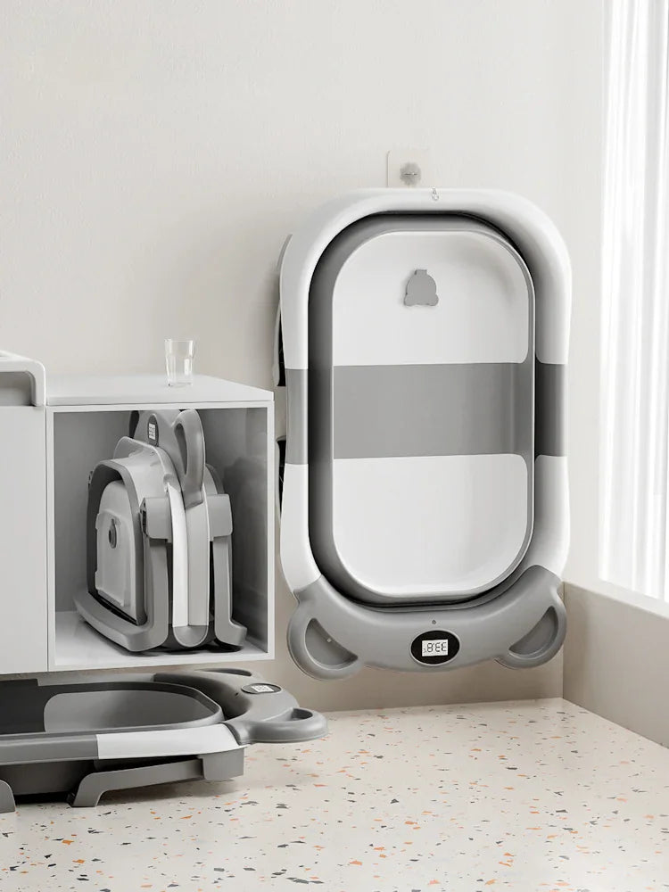 Folded grey and white baby bathtub next to an open one
