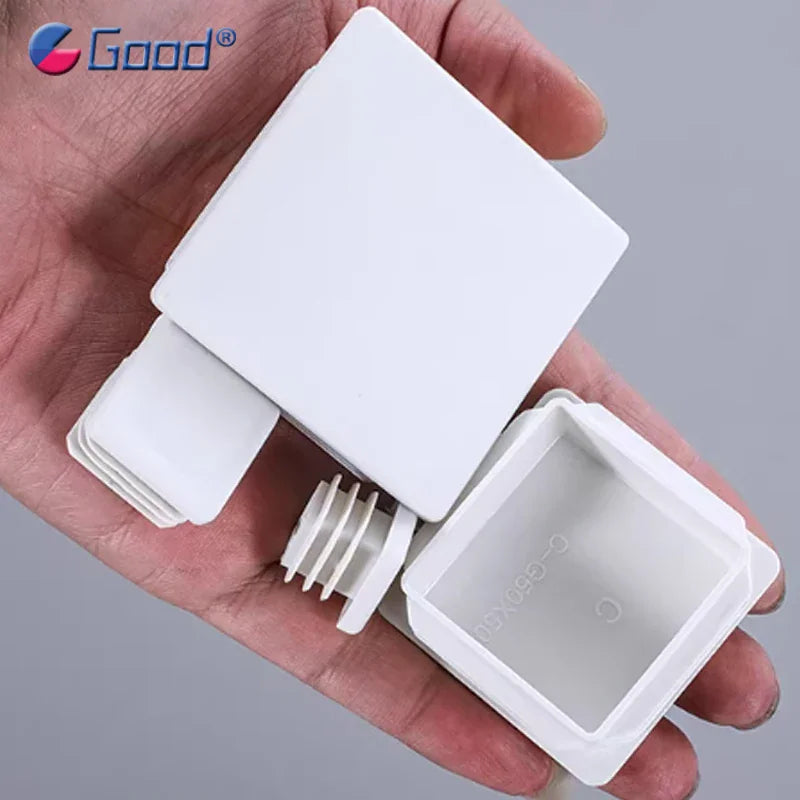 White plastic square tube inner plug cap in hand