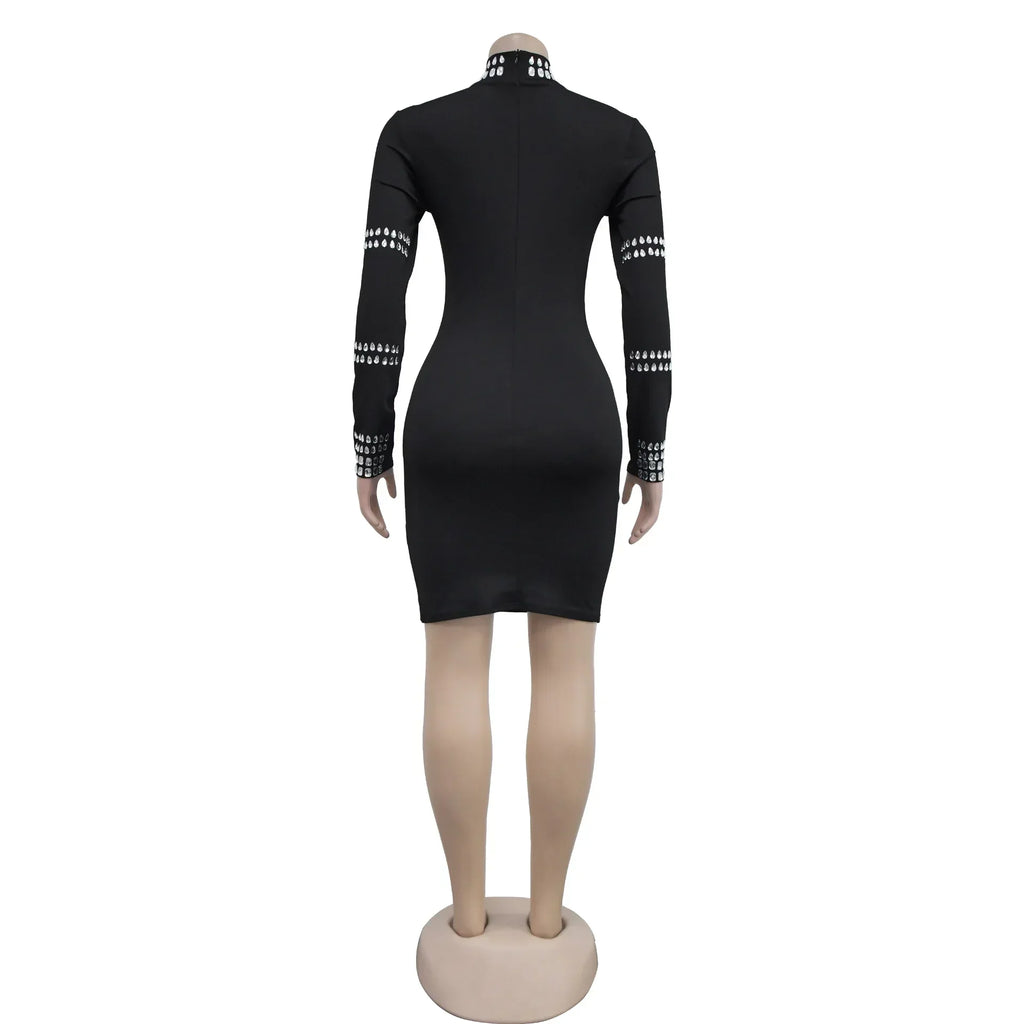 Back view of a black mini dress with long sleeves and silver rhinestone detailing on a mannequin.