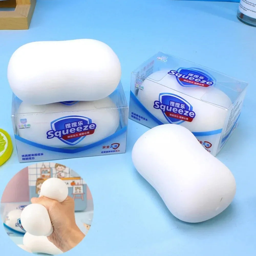 White soap-shaped stress relief squishy ball toy in individual retail packaging boxes