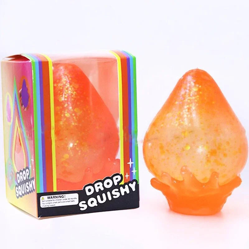 A single orange glittery water-drop squishy toy next to its rainbow-colored retail packaging box