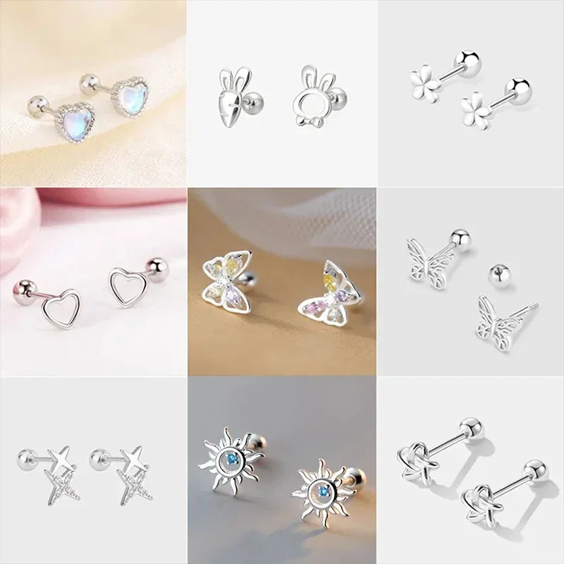 Collection of various 925 silver stud earrings including heart, butterfly, flower, and sun shapes