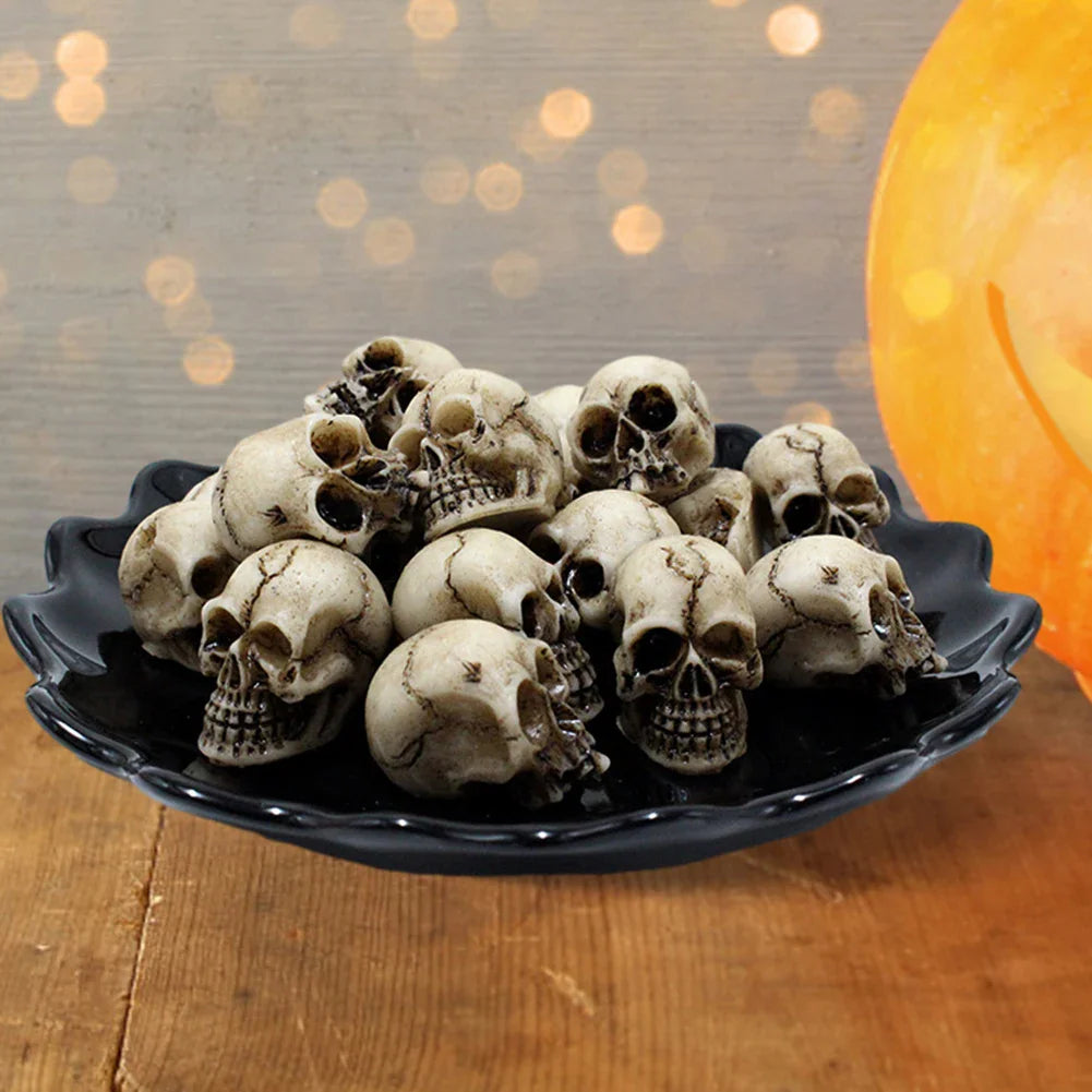 Miniature skull figurines arranged in a black decorative bowl