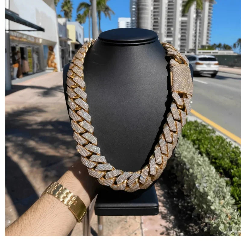 Gold-tone thick Cuban link chain with pave cubic zirconia stones on a black display bust