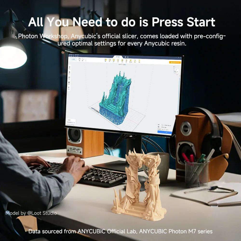 A workspace showing a computer monitor running 3D printing software and a printed model.