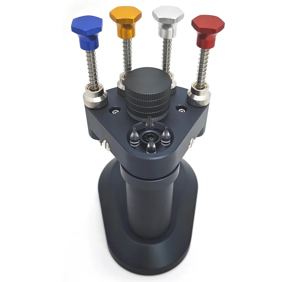 Top view of a watch hand installation tool with four colored adjustment knobs
