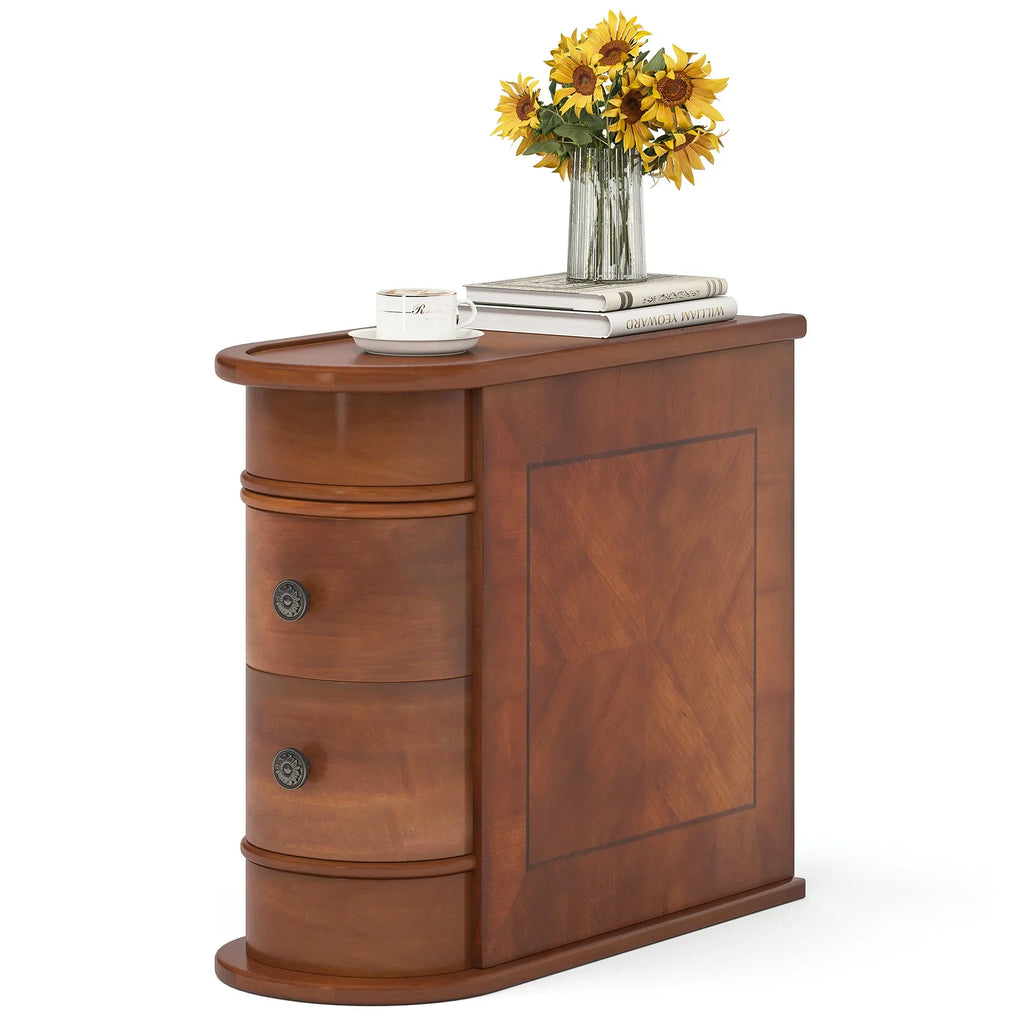 Standalone narrow wooden end table with two drawers, styled with a vase of sunflowers, books, and a cup