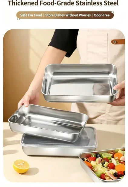 Person holding rectangular stainless steel food storage trays in a kitchen
