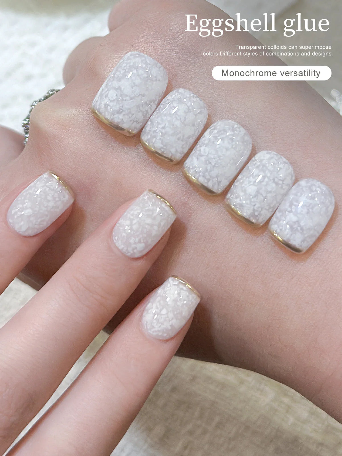 Hand showing white eggshell gel nail polish on manicured nails