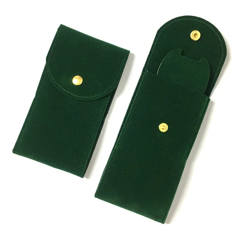 A dark green suede watch storage pouch with a snap button.