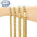 Four gold cuban link bracelets of varying widths displayed on a person's wrist