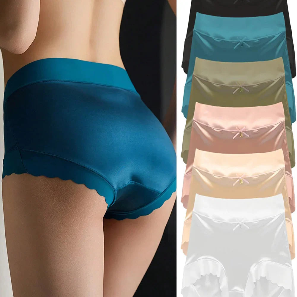 A woman wearing blue satin briefs and a selection of six colorful high-waisted satin panties.
