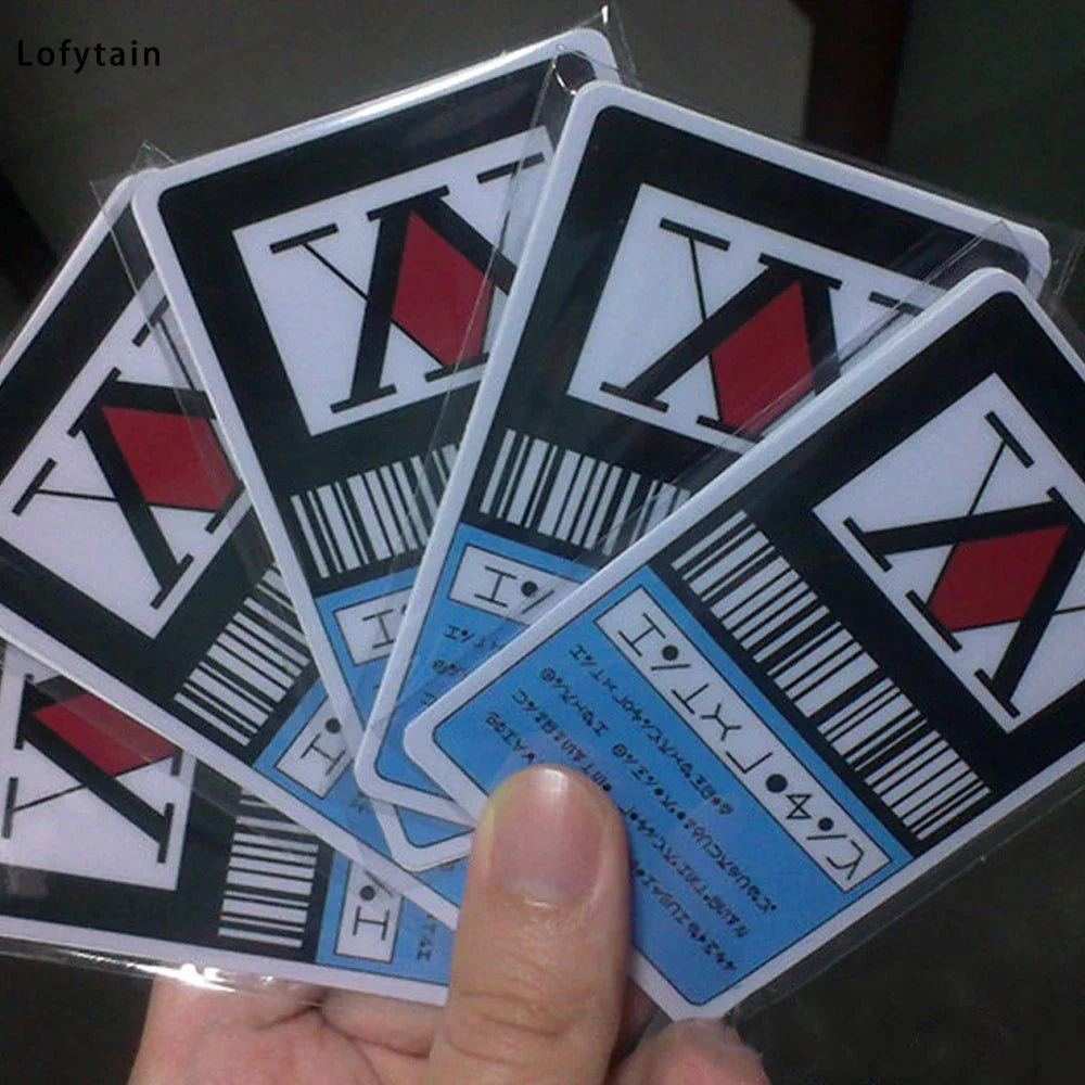 Hand holding a fan of multiple plastic anime-inspired license cards in clear sleeves