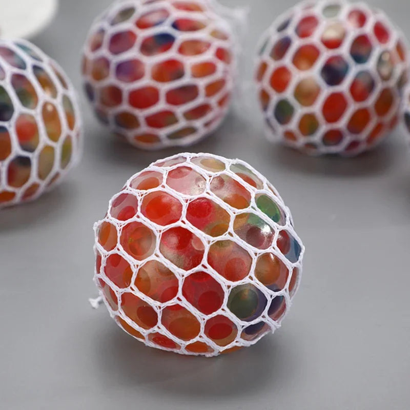 Several multi-coloured water bead stress balls in white mesh nets