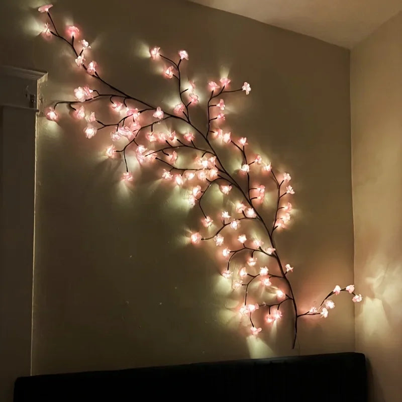 Glowing cherry blossom LED branch lights mounted on bedroom wall