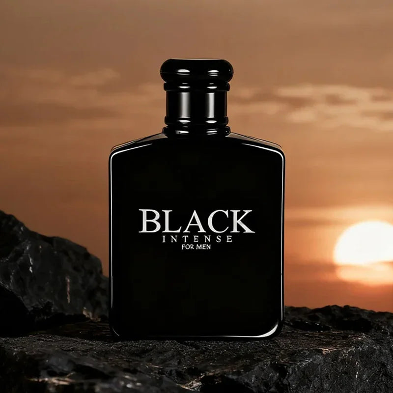 Black perfume bottle for men against a sunset background with rocks