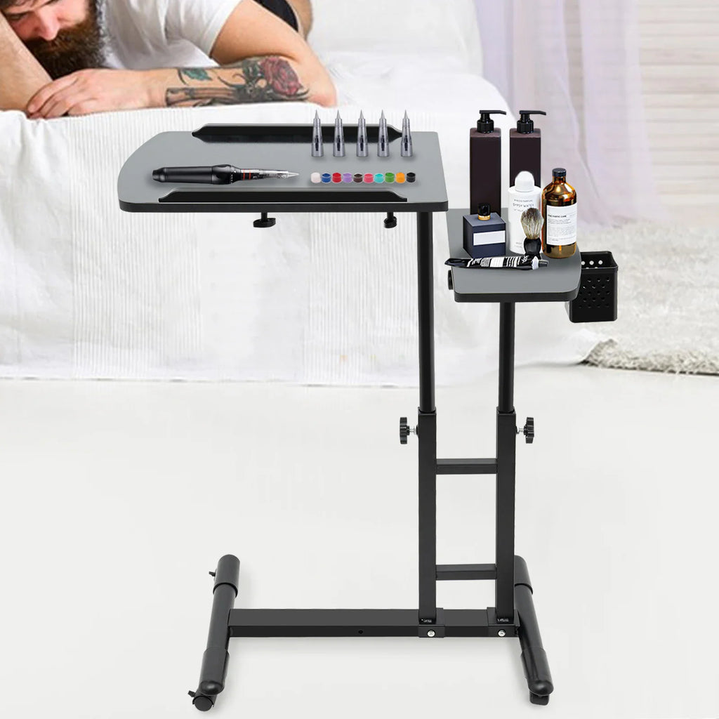 Adjustable height black tattoo workstation table with tools for tattoo artist