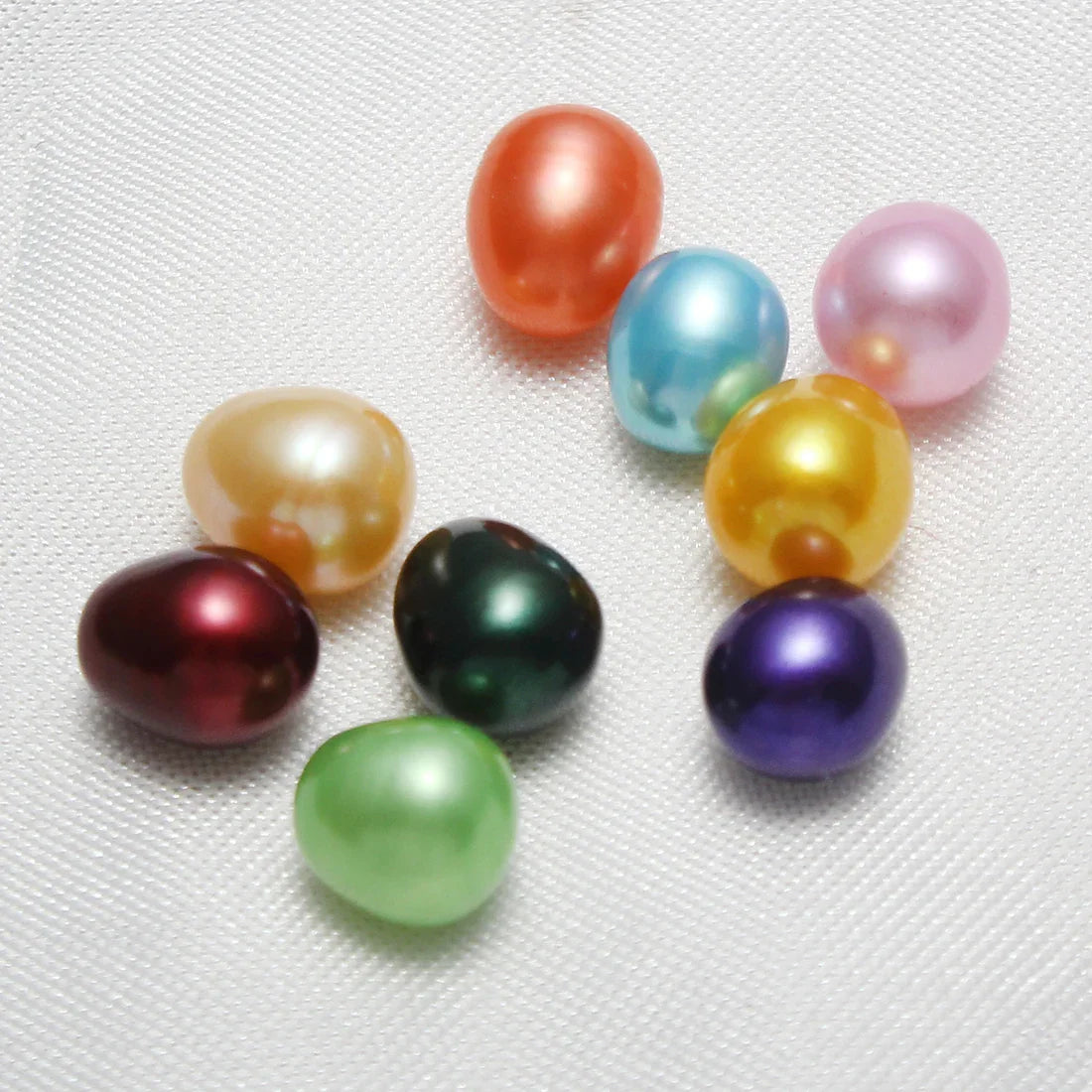 A collection of colorful round freshwater pearls in various shades
