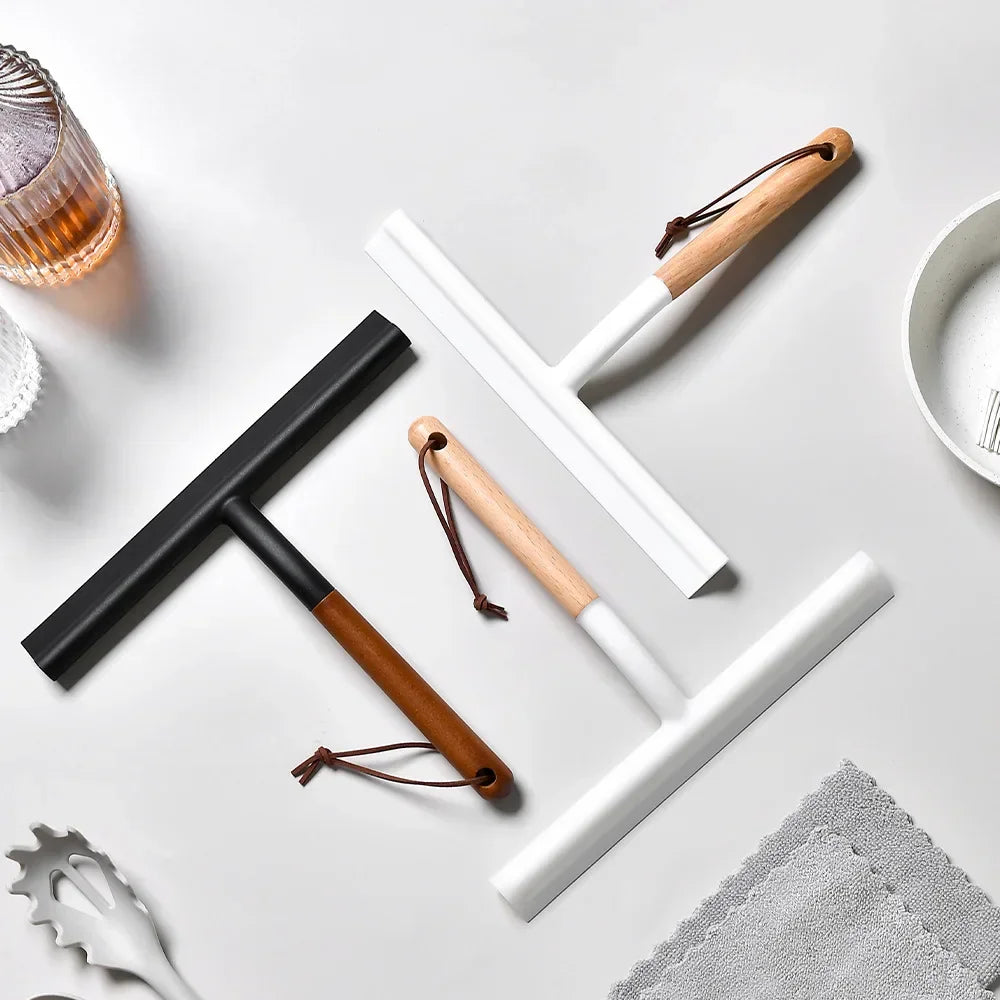 A collection of black and white silicone window wipers with wooden handles and hanging leather straps