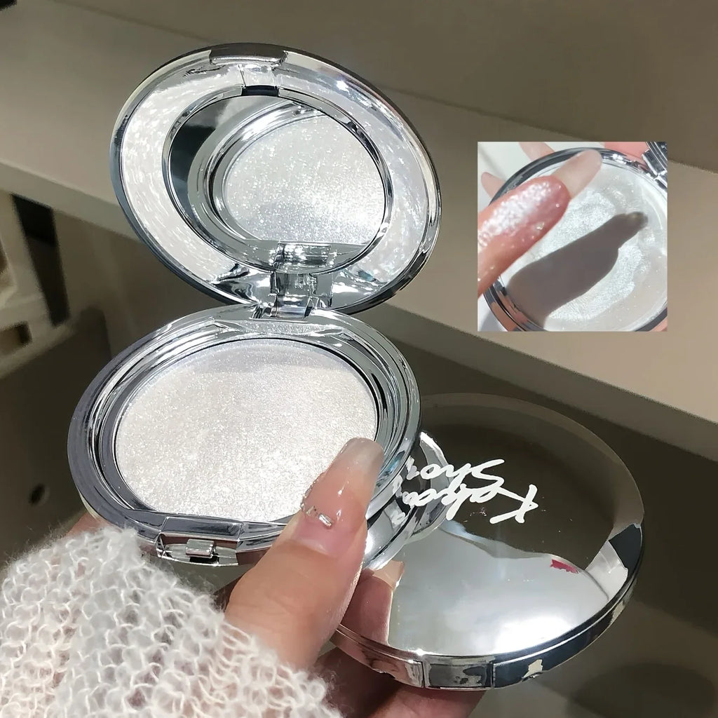 White shimmer highlighter compact and a finger swatch of the product