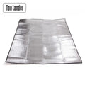 Silver aluminum foil and EVA foam camping mat laid flat on the ground.