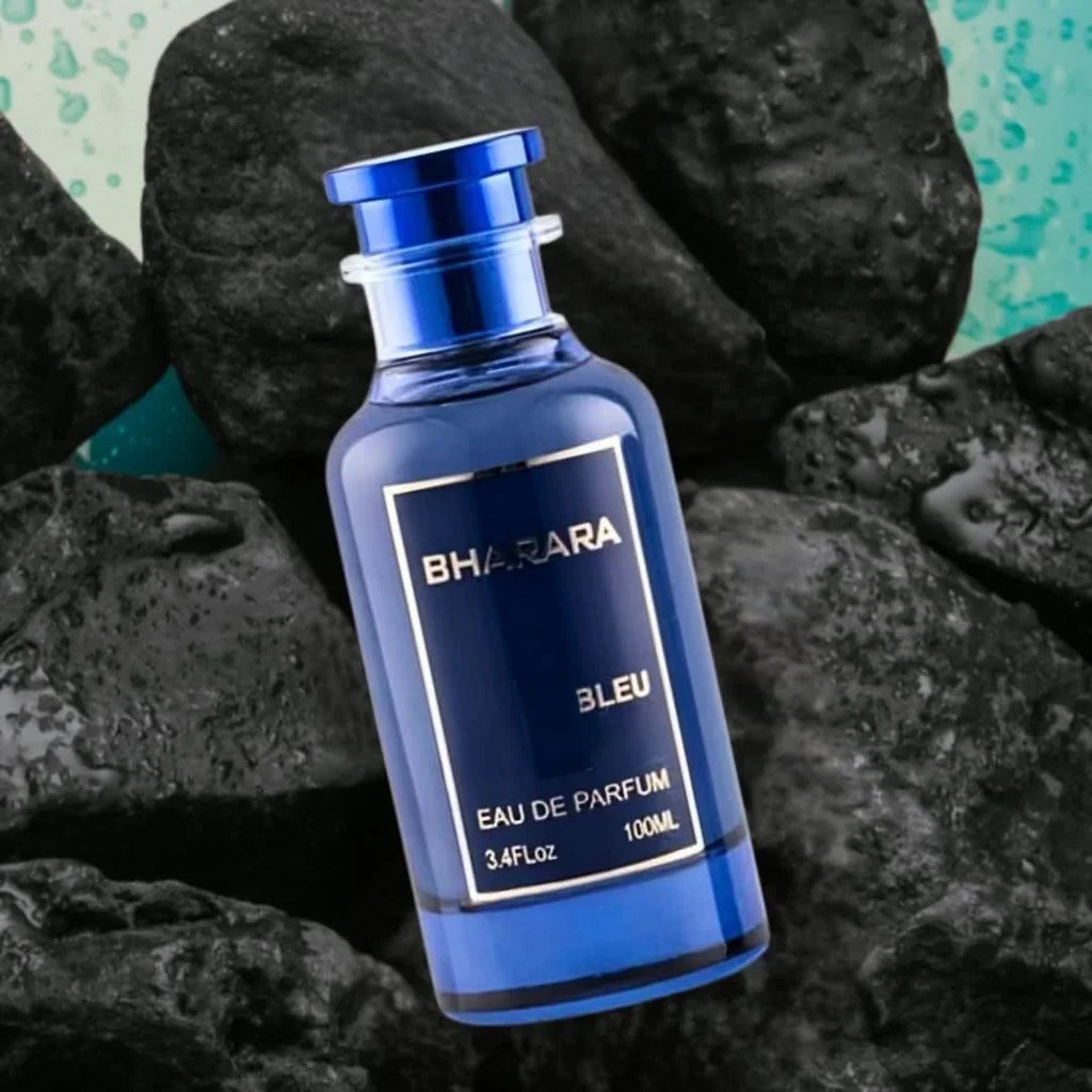 Blue perfume bottle standing on black rocks
