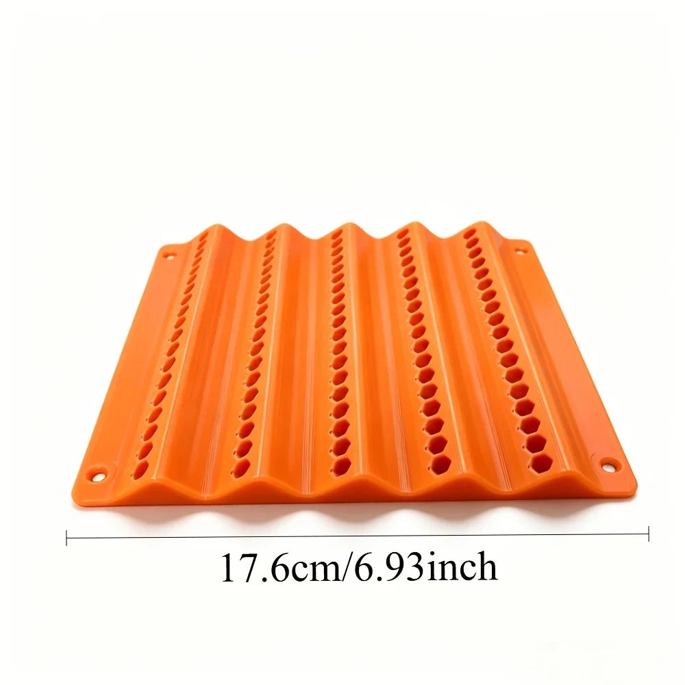 Empty orange plastic wall-mounted tool storage rack with hexagonal slots.