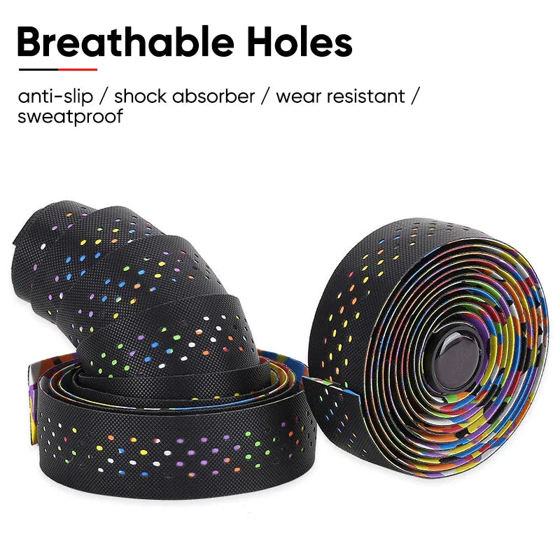 A close-up view of a perforated black and rainbow-patterned road bike handlebar tape