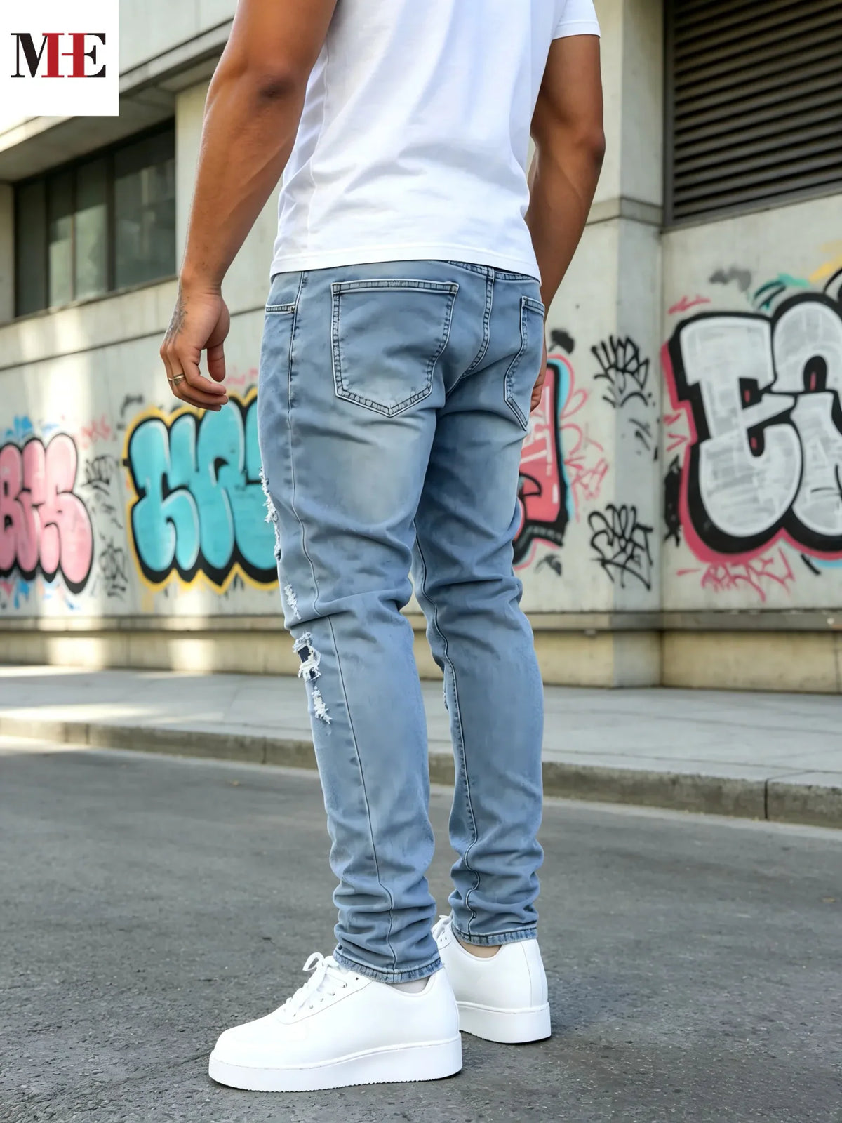 Back view of a man in light blue slim fit ripped skinny jeans showing pockets